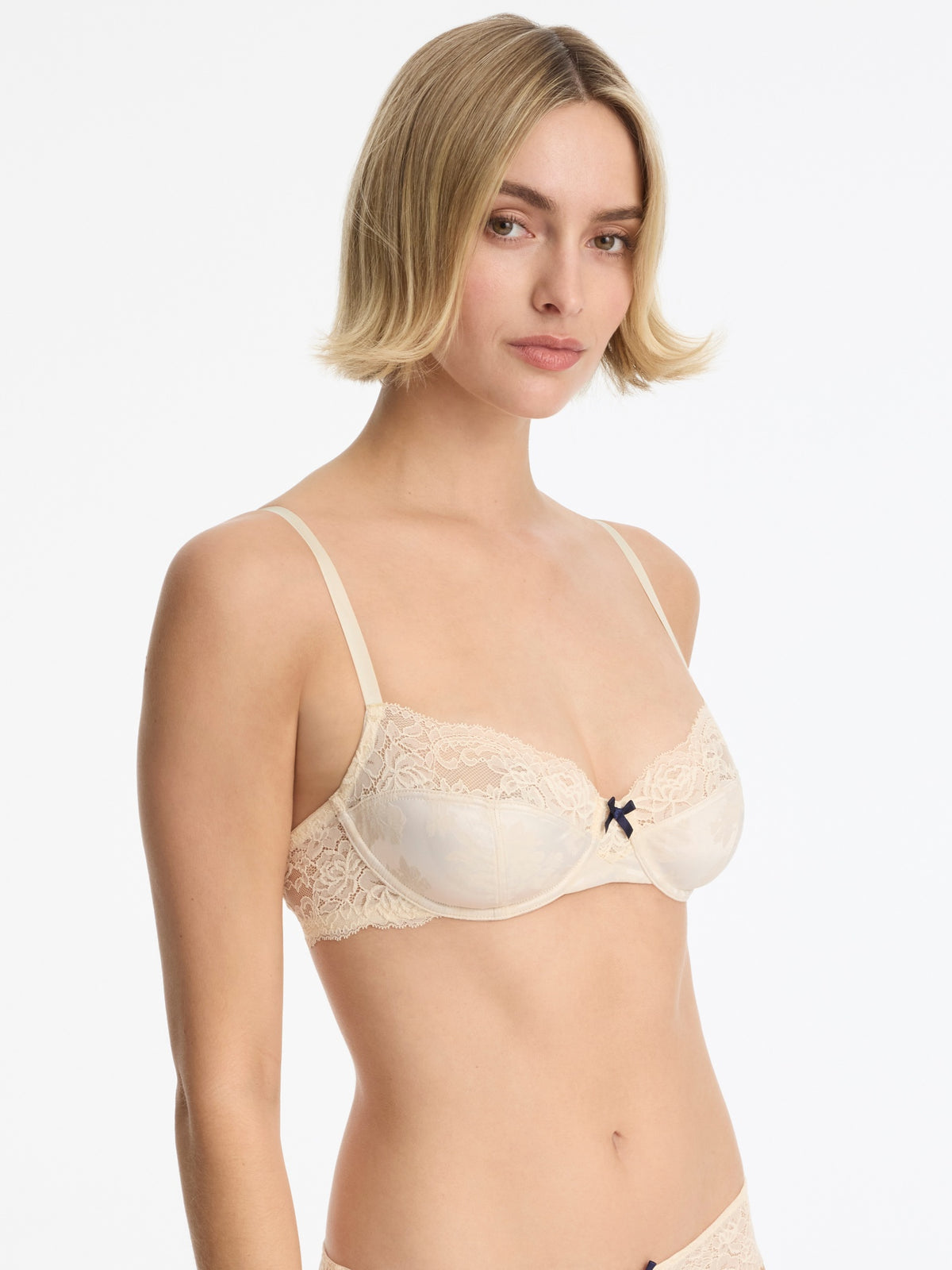 Skarlett Blue Captivate Satin & Lace Balconette Underwire Bra in Candlelight - model three-quarter view in underwire balconette bra with lace cups