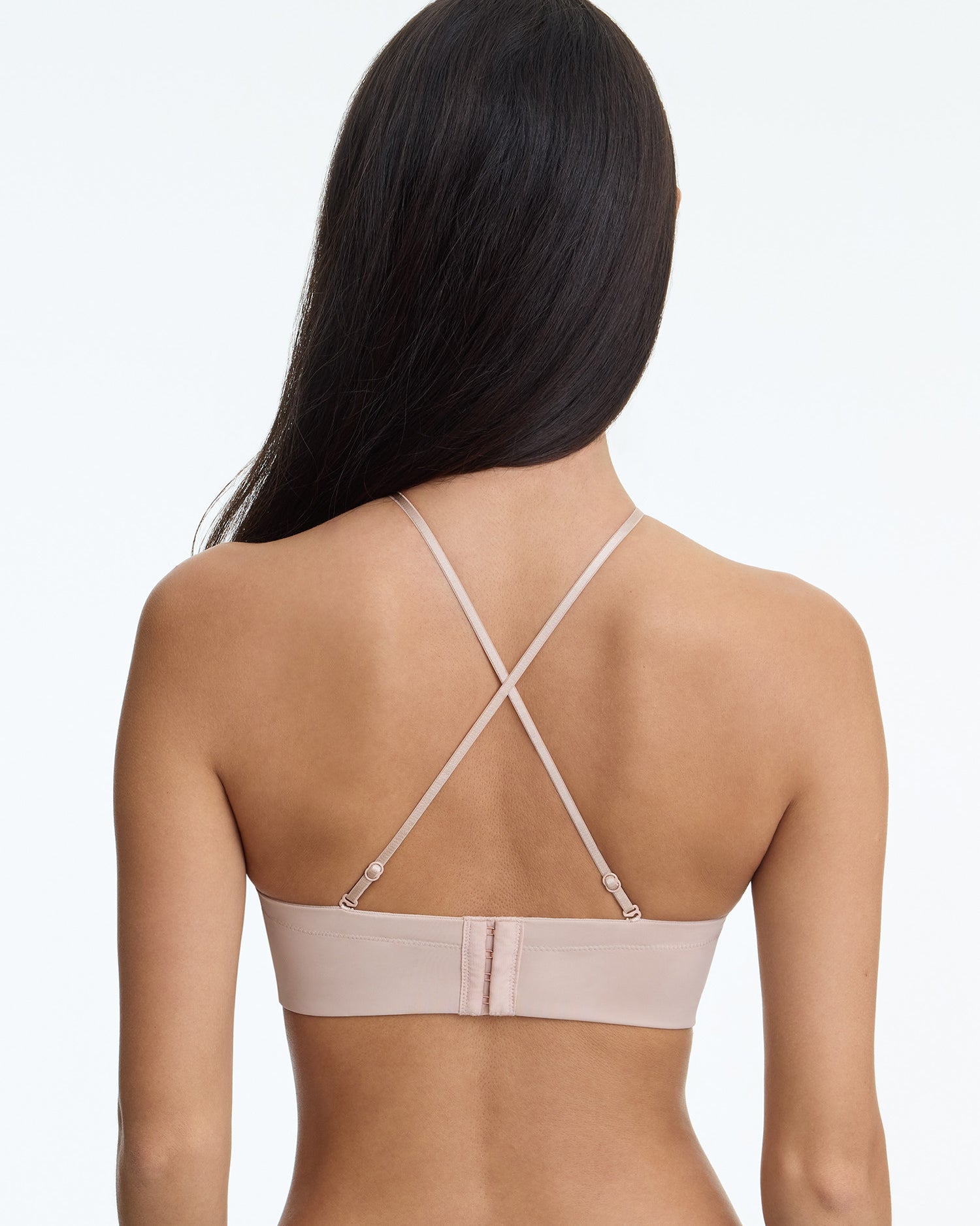Beige bra worn by a model on a white background