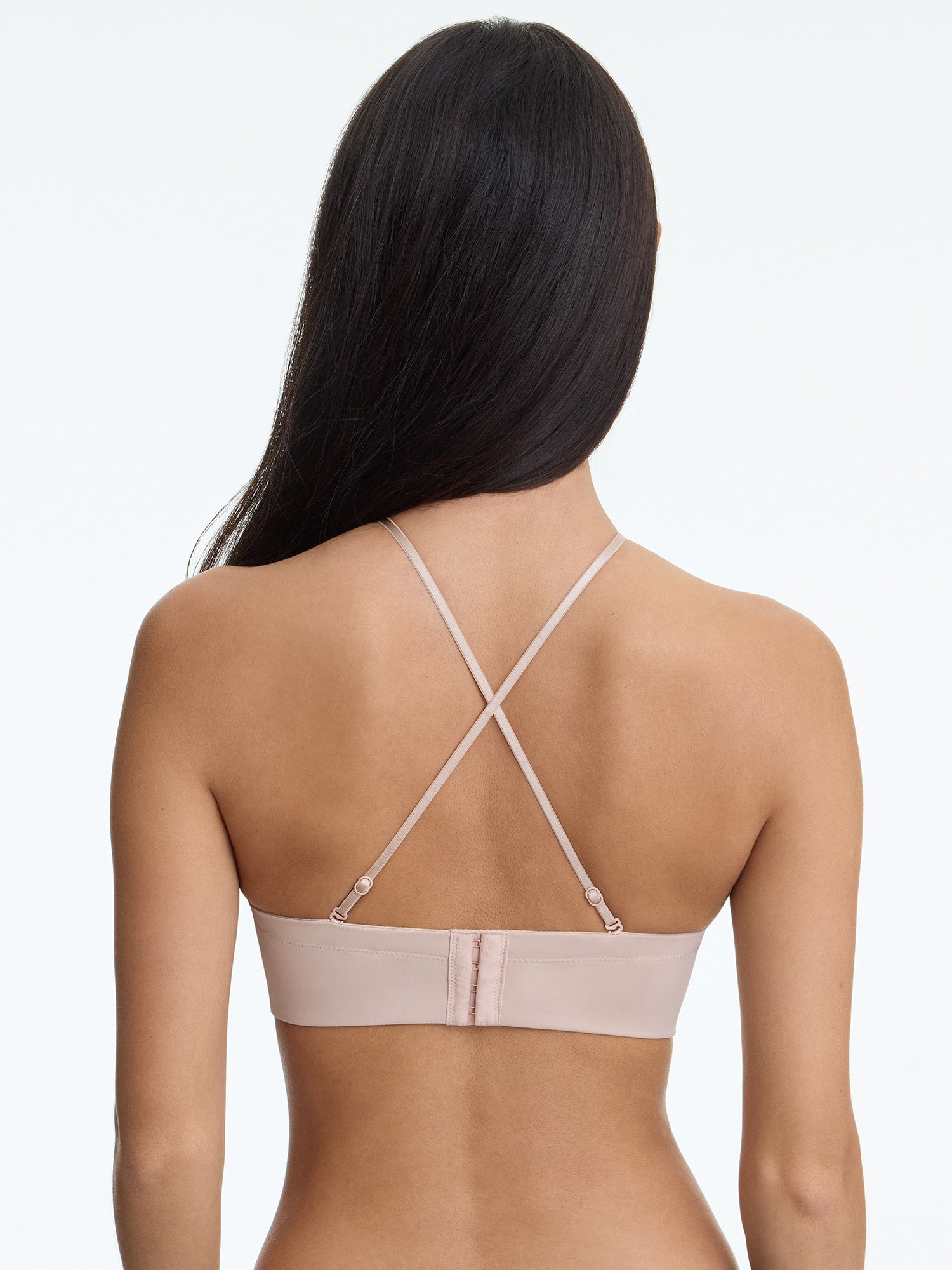 Beige bra worn by a model on a white background