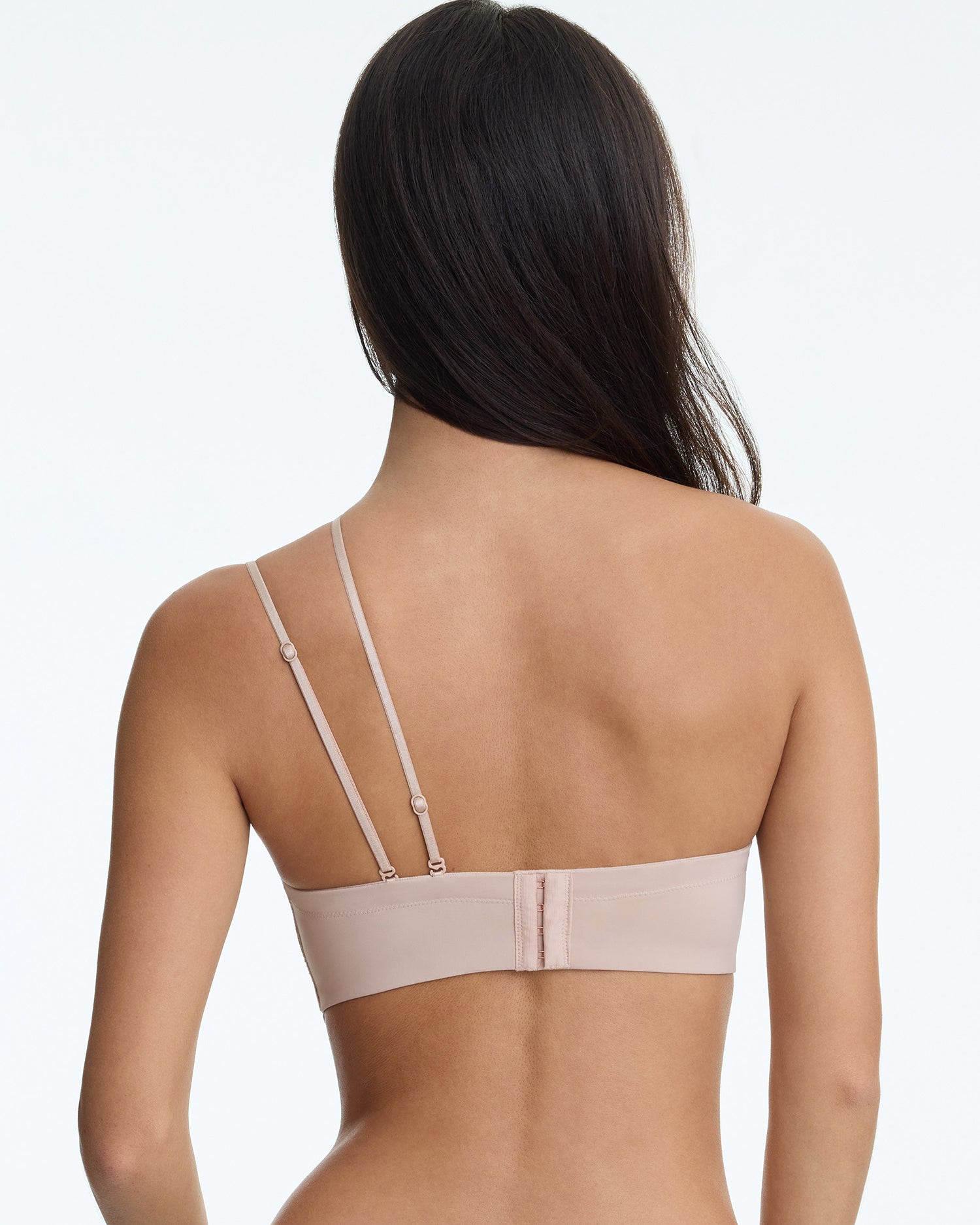 Woman wearing a beige bra on a white background