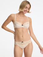 Skarlett Blue Captivate Satin & Lace Balconette Underwire Bra and Captivate Satin & Lace Bikini in Candlelight - model in matching bra and bikini underwear