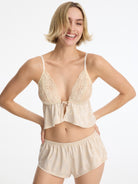 Skarlett Blue Captivate Satin & Lace Flutter Cami and Captivate Satin Flutter Short in Candlelight - model front view in lace cami and satin jacquard sleep shorts