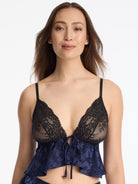 Skarlett Blue Captivate Satin & Lace Flutter Cami in Midnight/Black - model close-up front view in lace triangle cami with tie-front