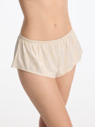 Skarlett Blue Captivate Satin Flutter Short in Candlelight - model three-quarter close-up in satin jacquard sleep shorts with elastic waist