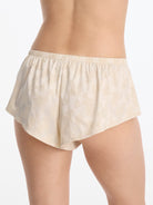 Skarlett Blue Captivate Satin Flutter Short in Candlelight - model back view in satin jacquard sleep shorts with flutter hem