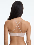 Beige bra worn by a model on a white background