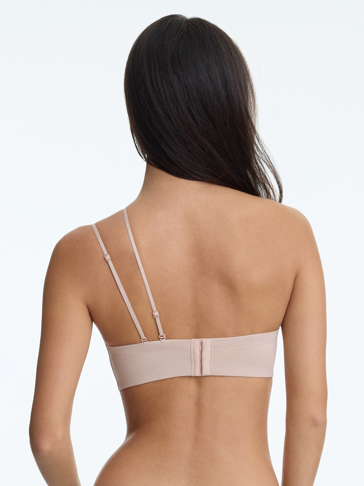 Woman wearing a beige bra on a white background